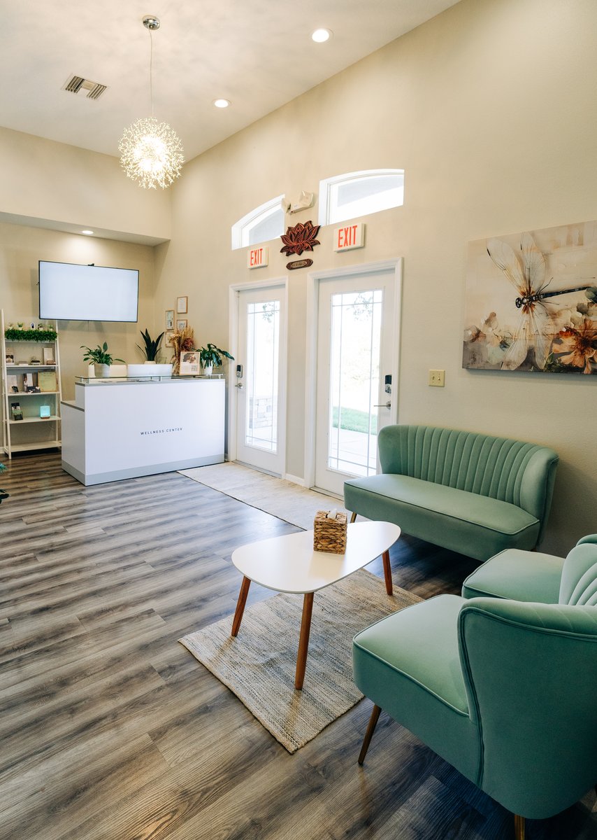 Belle Vie lobby — reception desk, seating and dragonfly welcome wall